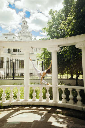 young woman doing yoga outside in natural environmentの写真素材