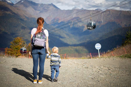 Rosa Khutor long cable car. Cubicles. Autumn. Mom travels with her son.