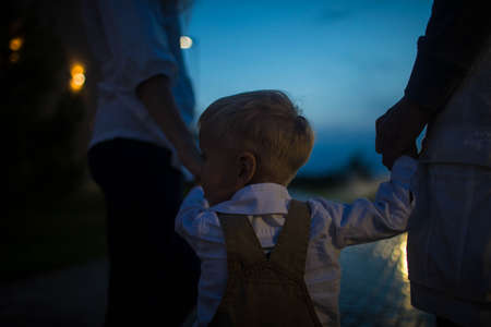 Family walk around the city late at night. Close up.の写真素材