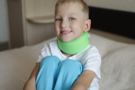 Little boy wearing Cervical Collar accusing neck pain (Cervicalgia) and Torticollis. Common Childhood Injuries Conceptの写真素材