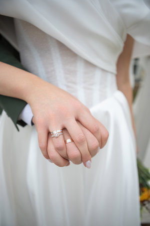 Close-up of the bride and grooms hands with wedding rings.の写真素材