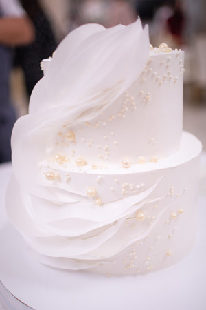 Two-tiered white wedding cake. Close-upの写真素材