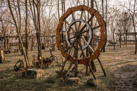 Old wooden wheel in horse farmの写真素材