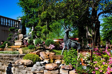 Asian Garden Statue and flowersの写真素材