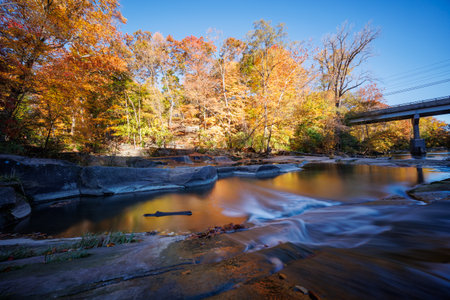 Long Exposure River in Autumn with Bridgeの写真素材
