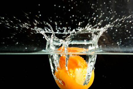 apricot in the water on a black backgroundの写真素材