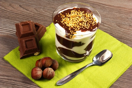 chocolate dessert with hazelnuts and chocolate bar on the tableの写真素材