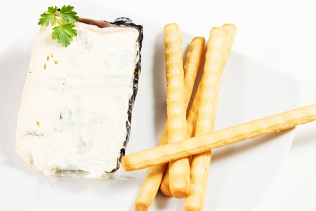 piece of Italian gorgonzola cheese and bread stick
