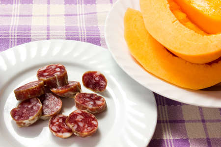 salami and melon in the dish on the tableの写真素材
