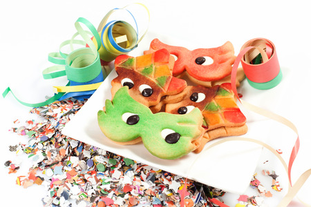carnival cookies on the white background with confetti and streamersの写真素材
