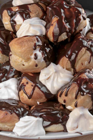 Cream puffs filled with cream covered with chocolateの写真素材