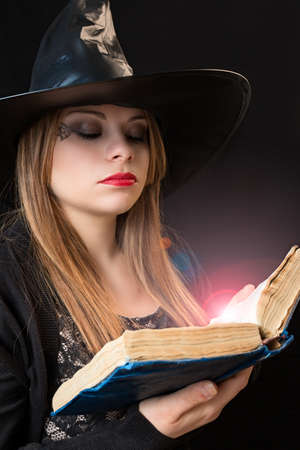 blond witch with spellbook