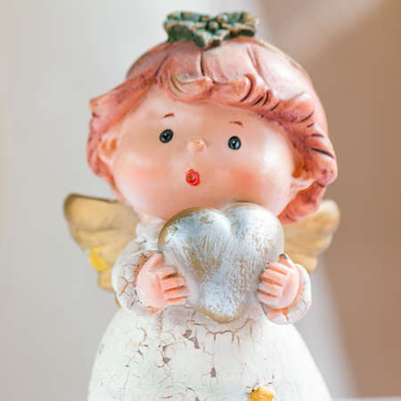 statue of angel with heart in handの写真素材