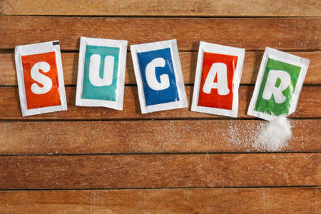 sugar sachets on wooden floorの写真素材