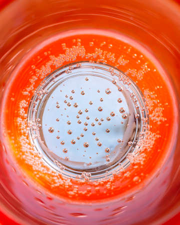 orange sparkling water with bubbles