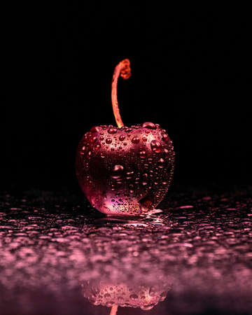 wet cherry in red lightの写真素材