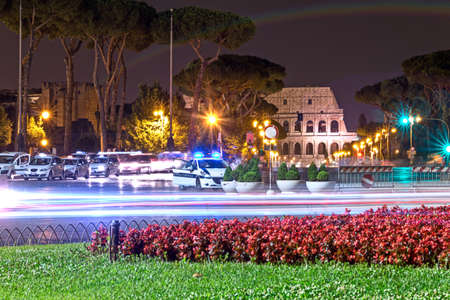 view of the coliseum in the night with police carの写真素材