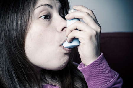 girl inhales medicineの写真素材