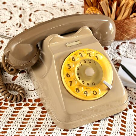 vintage telephone with hands on white backgroundの写真素材