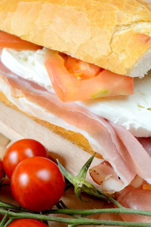 bread baguette with ham mozzarella and tomatoの写真素材