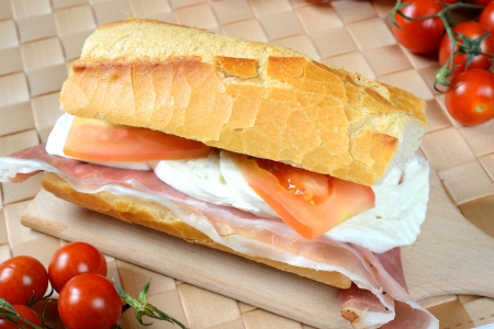 bread baguette with ham mozzarella and tomatoの写真素材