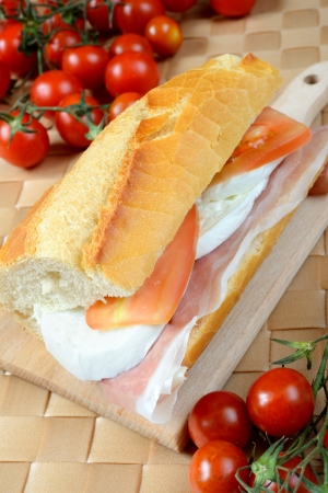 bread baguette with ham mozzarella and tomatoの写真素材