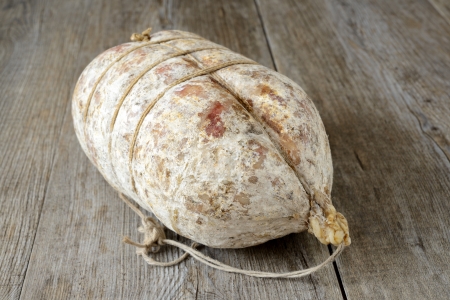 specialty sacked seasoned soppressata of fragrant wooden tableの写真素材