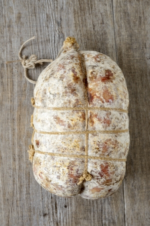 specialty sacked seasoned soppressata of fragrant wooden tableの写真素材