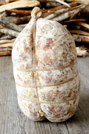specialty sacked seasoned soppressata of fragrant wooden tableの写真素材