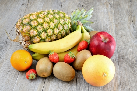 various fresh colored  fruit on wooden tableの写真素材