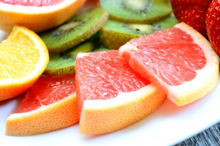 various fresh colored  fruit on wooden tableの写真素材