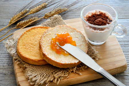 Breakfast with dutch golden crunchy rusks and apricot jamの写真素材