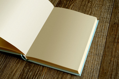 blank page of opened book on wooden table