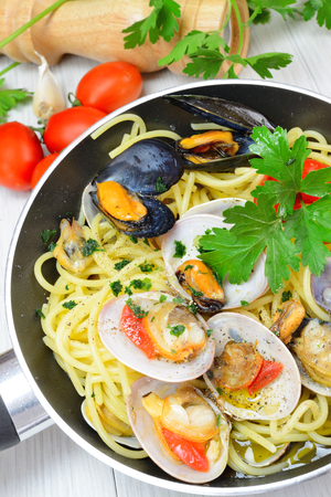 italian traditional food composed by spaghetti pasta and seafood fasolari,clams and musselsの写真素材