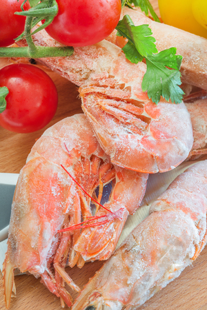 Frozen shrimp with tomatoes and yellow pepperの写真素材