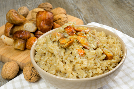 risotto with porcini mushrooms on wooden tableの写真素材