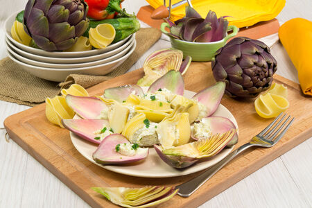 traditional lumaconi pasta filled with artichoke ricotta cream, butter and pepeprの写真素材