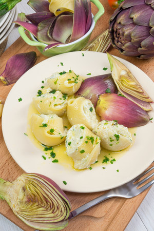 traditional lumaconi pasta filled with artichoke ricotta cream and butterの写真素材