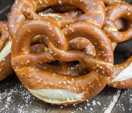 typical bavarian pretzel on old wooden tableの写真素材