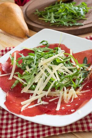 bresaola seasoned with olive oil, rocket and parmesan flakesの写真素材
