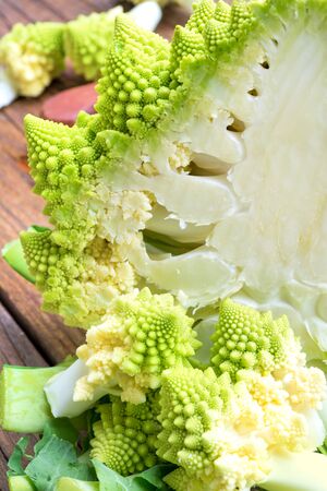 Raw roman cabbage on old wooden tableの写真素材