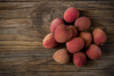 fresh litchis on old wooden table