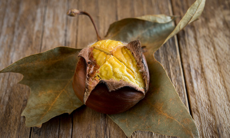 grapes, chestnuts and apples autumn fruits on wooden tableの写真素材