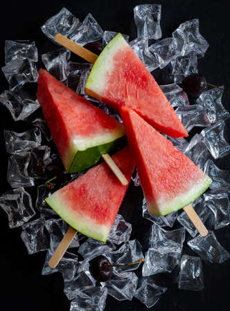Watermelon cut into a shape of ice cream on ice cubesの写真素材