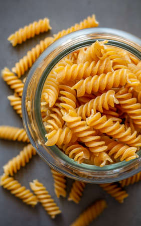 Typical wholemeal fusilli pasta with background out of focusの写真素材