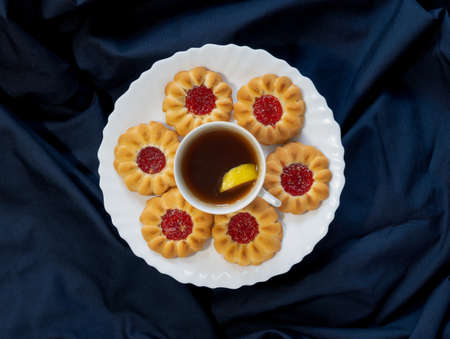 Sweet dried cookies with jam ideal and cup of teaの写真素材