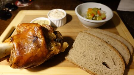 Schweinshaxe, in German cuisine, is a roasted ham hock (or pork knuckle). The ham hock is the end of the pig's leg, just above the ankle and below the meaty ham portion.の写真素材