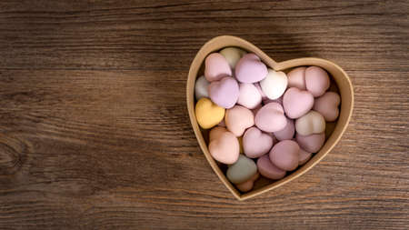 Hearts on the wooden background. Heart gift box. A lot of hearts.の写真素材
