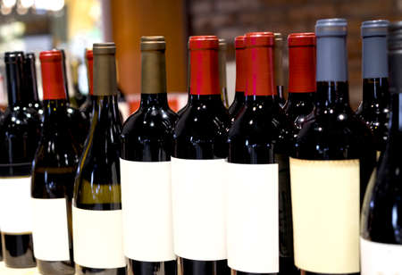 Wine shop. Closeup shot of wineshelf. Bottles lay over straw.