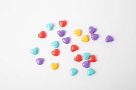Miniature plastic hearts love on white backgroundの写真素材
